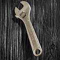 Adjustable Wrench over Black and White Wood 72
